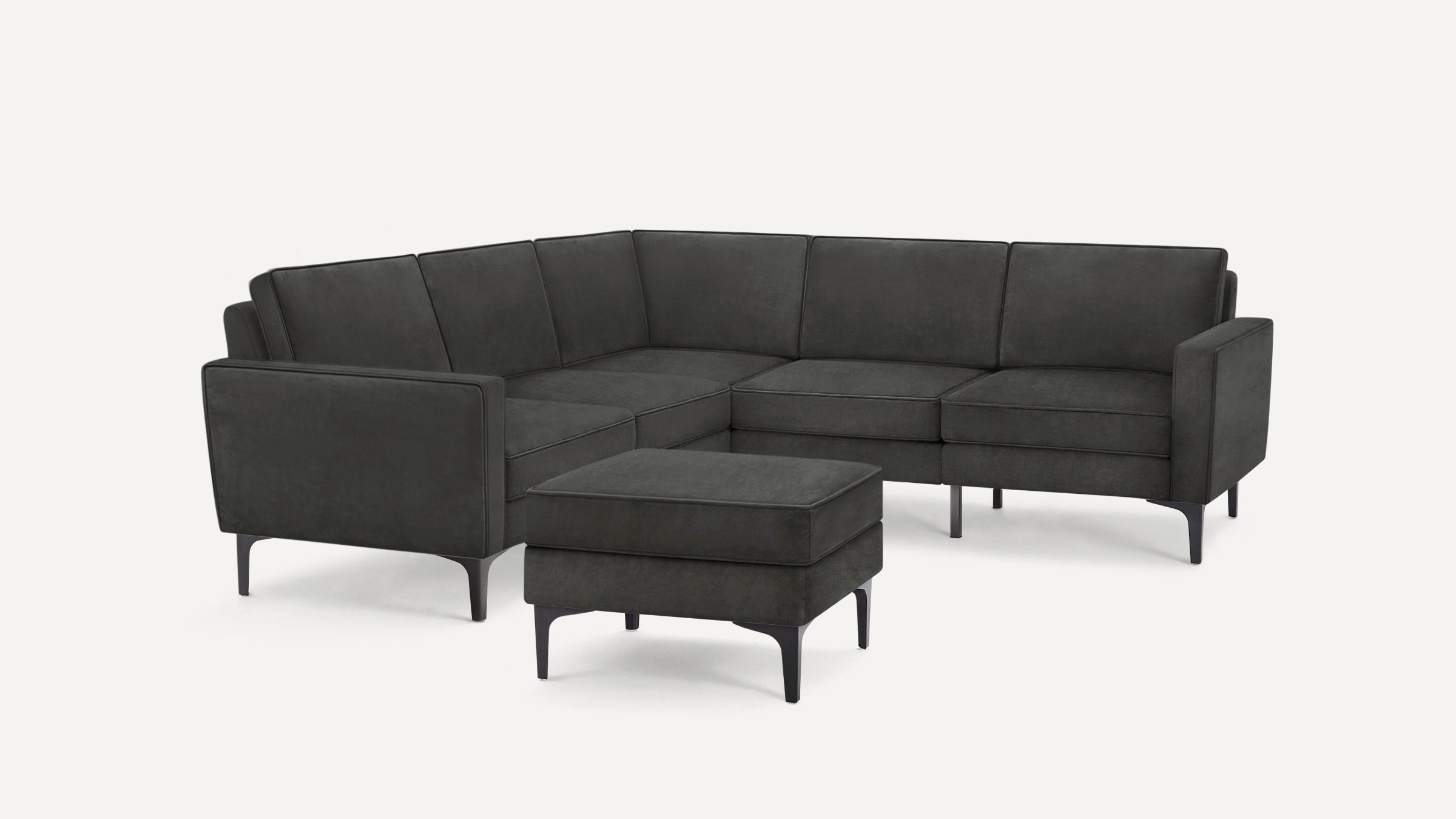 Dark gray modern sectional sofa with clean lines and slim legs, accompanied by a matching ottoman.