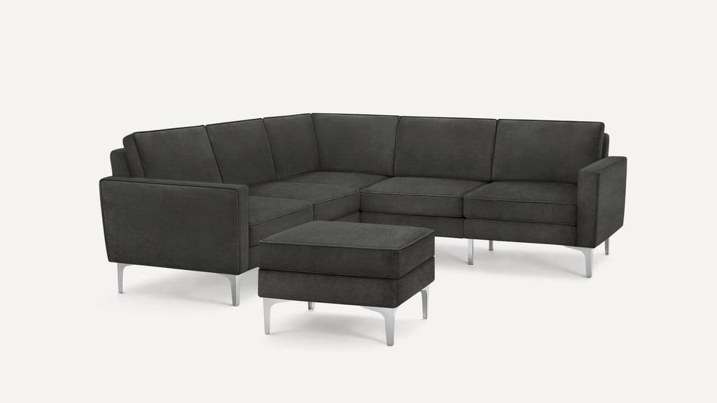 Modern dark grey sectional sofa with clean lines, chrome legs, and a matching ottoman against a plain white background.