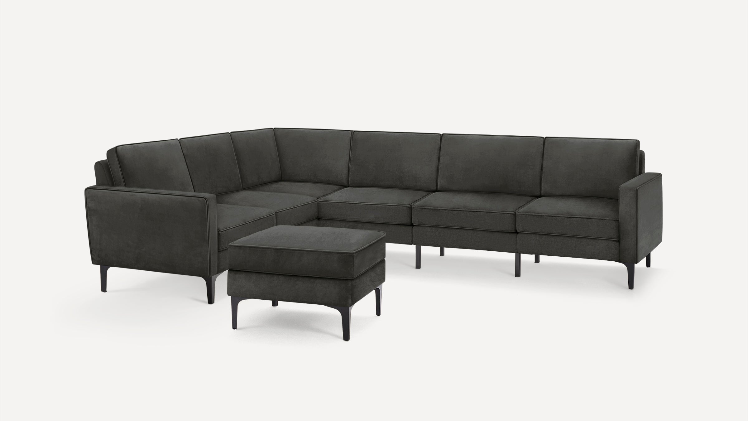 Dark gray modern sectional sofa with clean lines and matching ottoman, set against a plain white background.