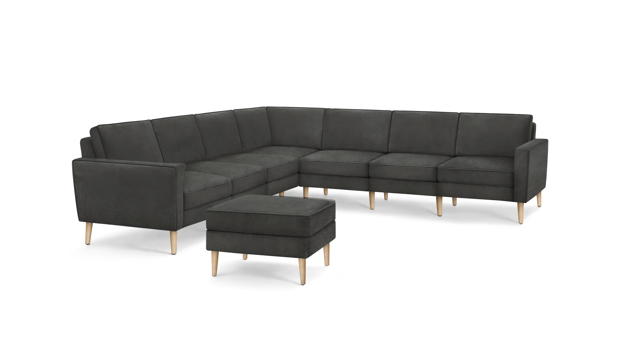 dark gray sectional sofa with wooden legs and matching ottoman, featuring a tufted backrest, and matching ottoman, featuring a matching ottoman