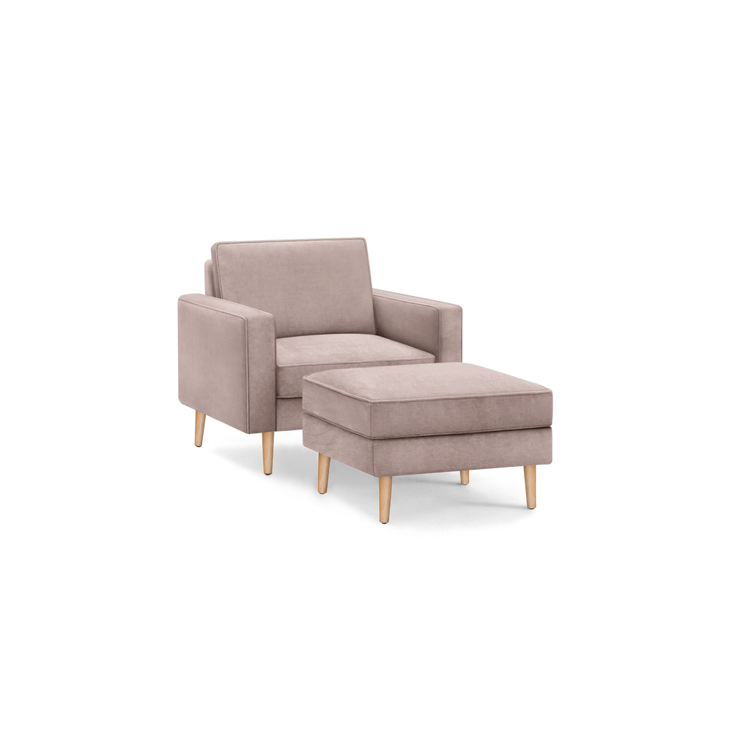 modern light pink upholstered armchair with matching ottoman, featuring tapered wooden legs and a sleek backrest