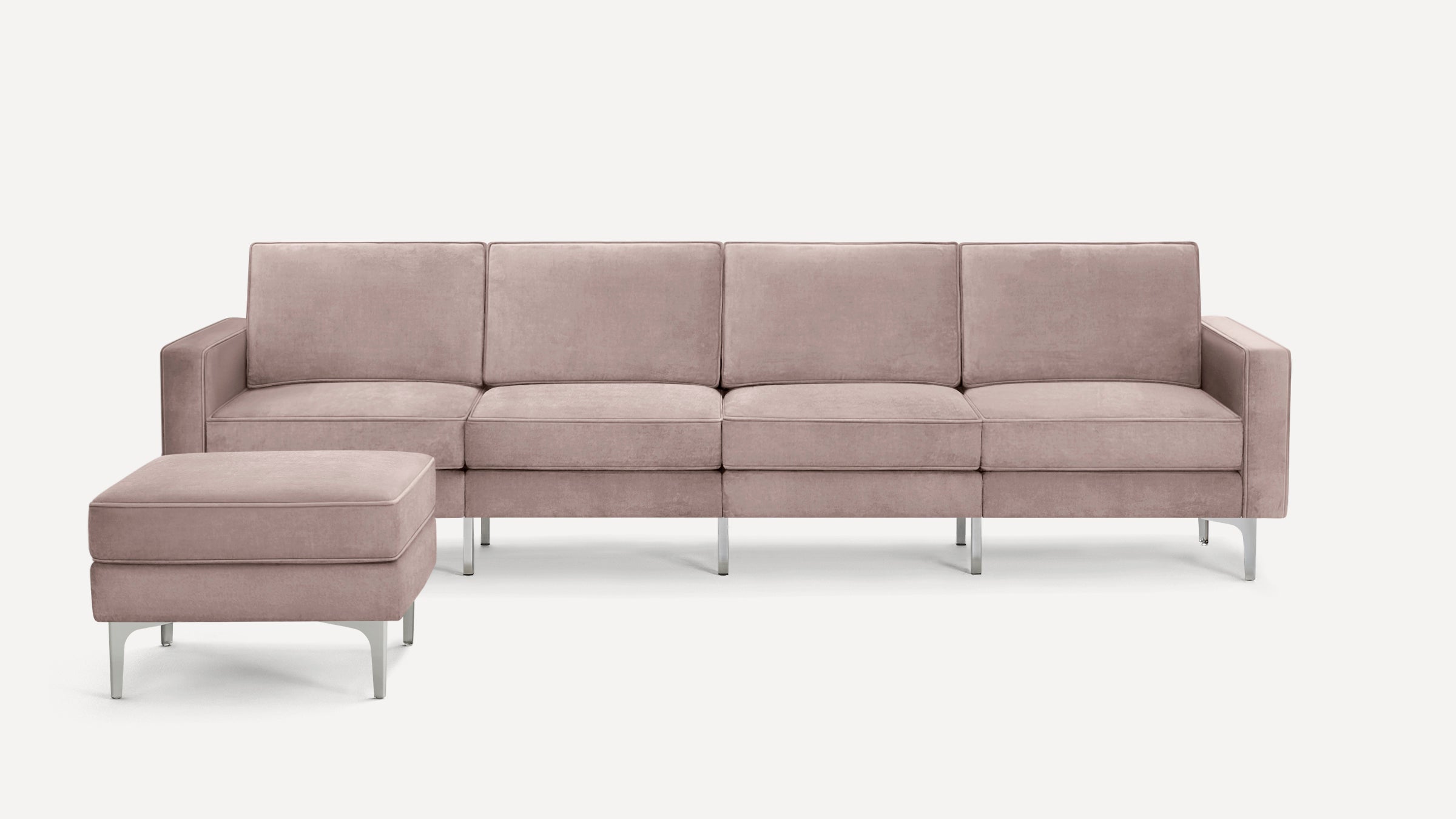 Modern L-shaped sectional sofa in soft dusty pink fabric with metal legs and a matching ottoman on a white background.