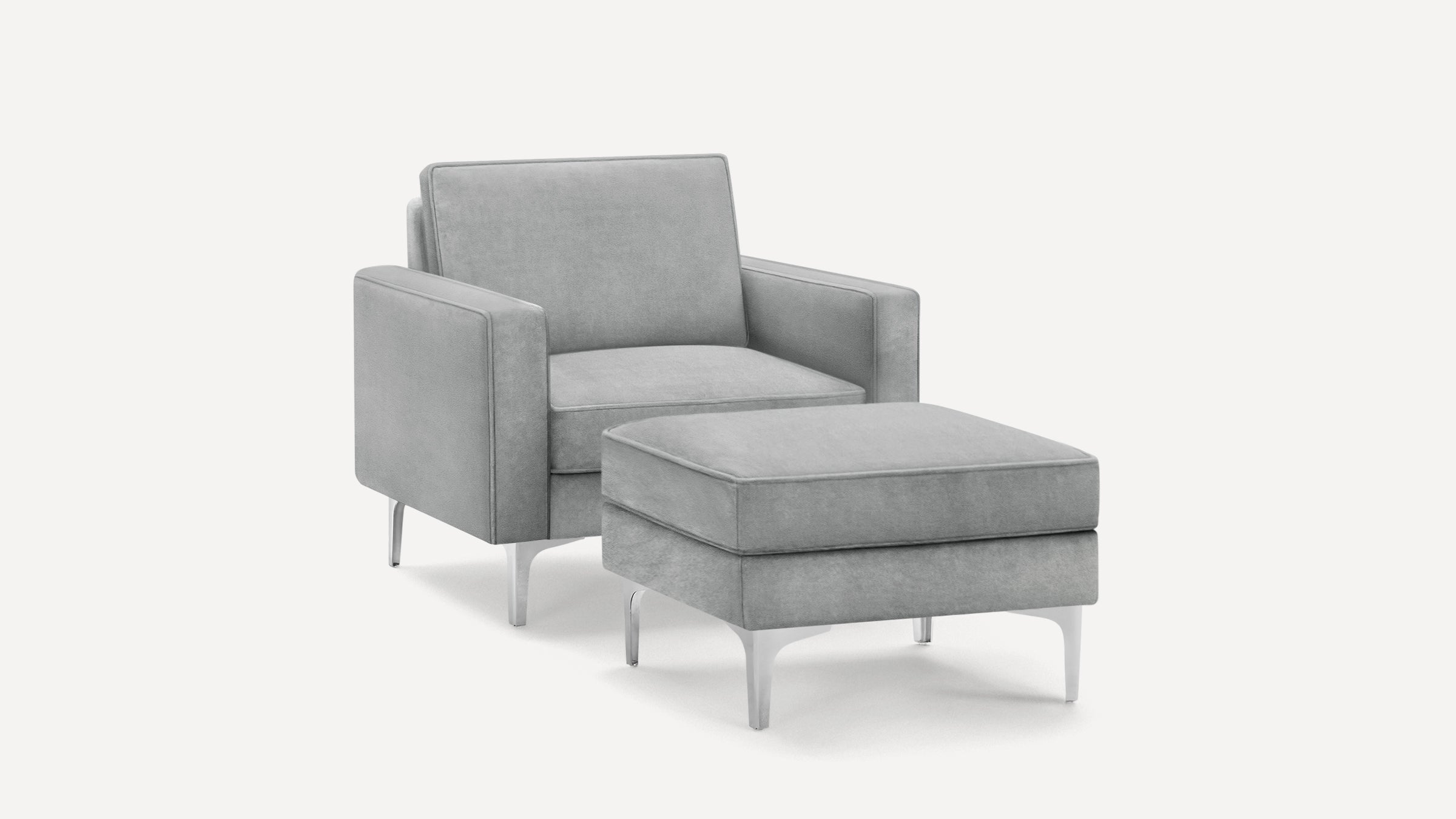 Modern gray upholstered armchair with matching ottoman, featuring sleek metal legs and clean, minimalist design.