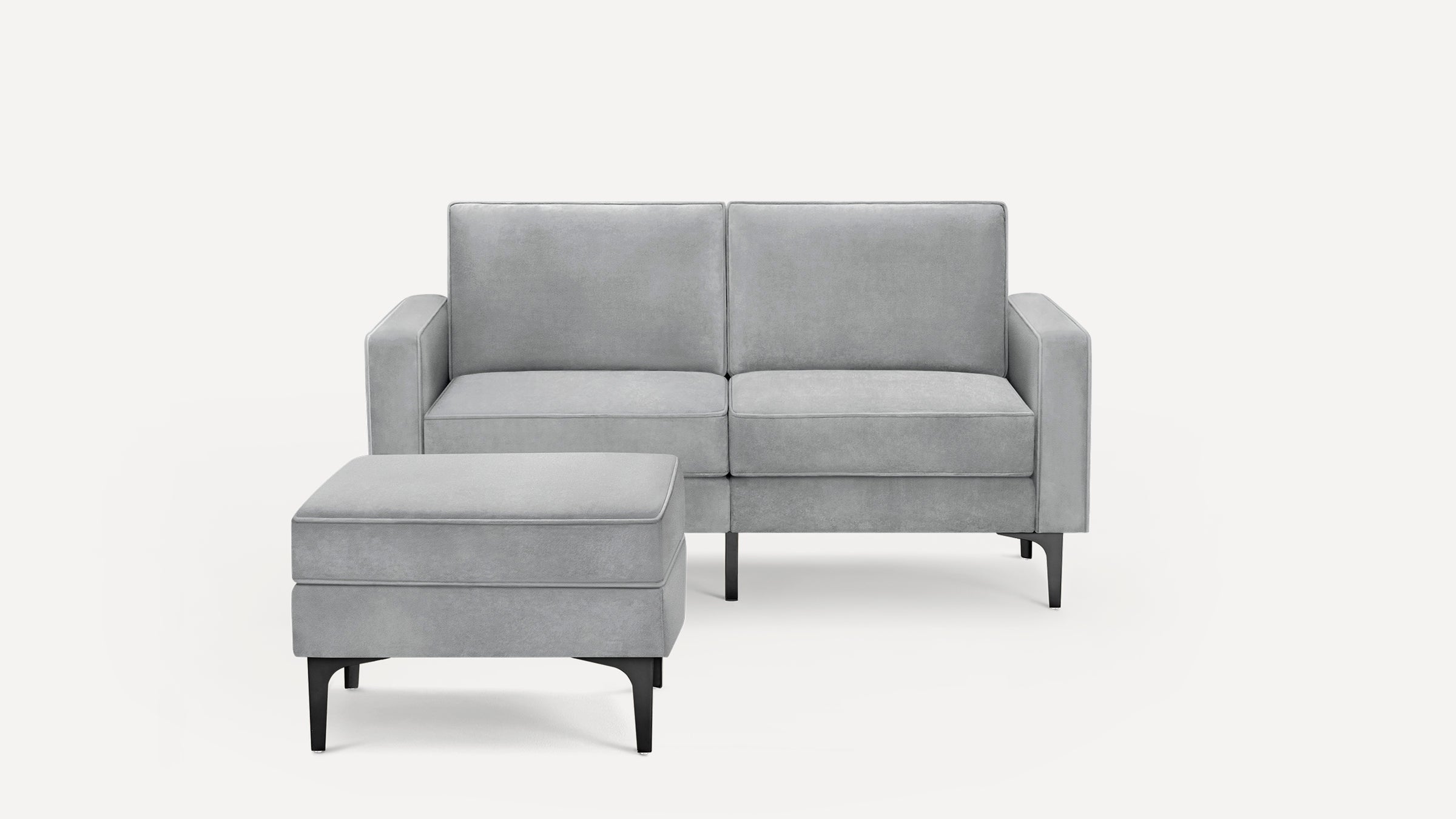 Modern light gray two-seater sofa with matching ottoman, featuring clean lines and black metal legs, against a white background.