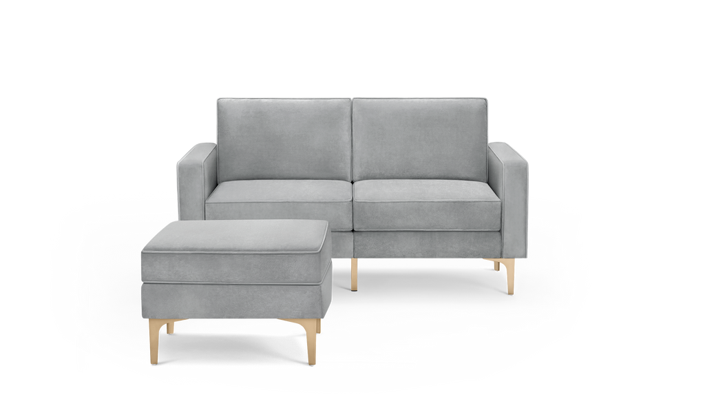 modern light gray velvet sofa with matching ottoman and wooden legs, featuring a sleek design and clean lines