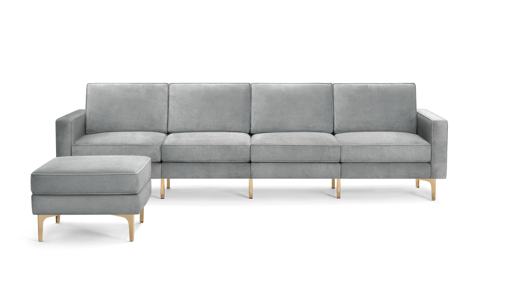 modern light gray velvet sectional sofa with matching ottoman, featuring a sleek metal frame and sleek lines on the back, along with a gold metal