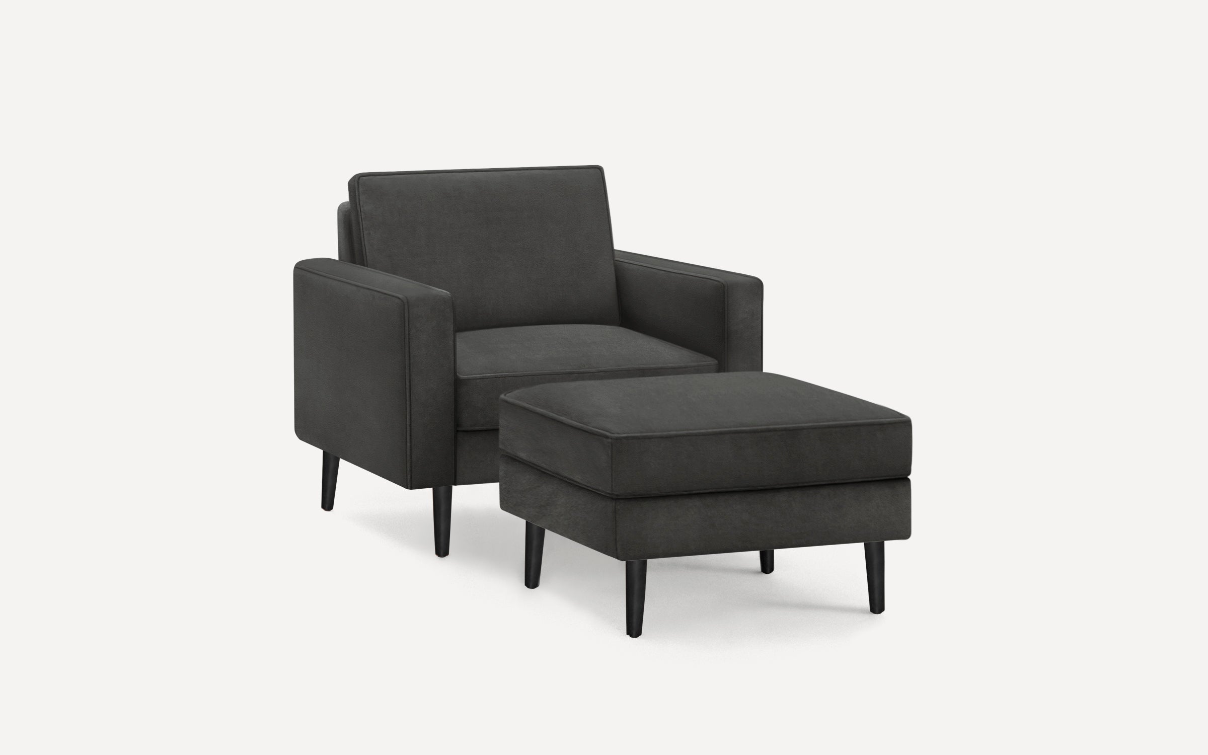 Dark gray upholstered armchair with matching ottoman, featuring clean lines and black tapered legs on a white background.