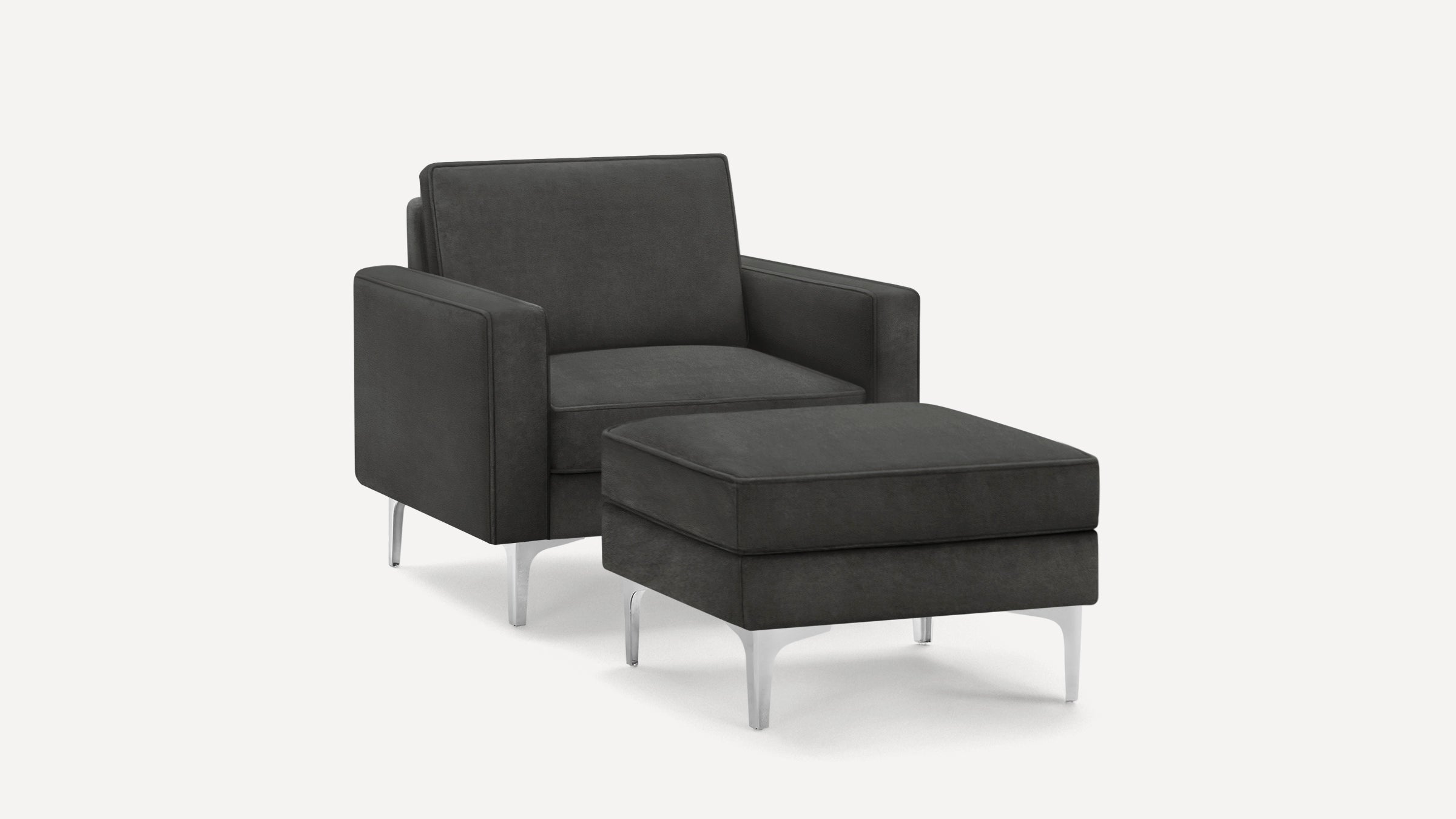 Dark gray upholstered armchair with matching ottoman, both featuring sleek chrome legs and clean, modern lines.