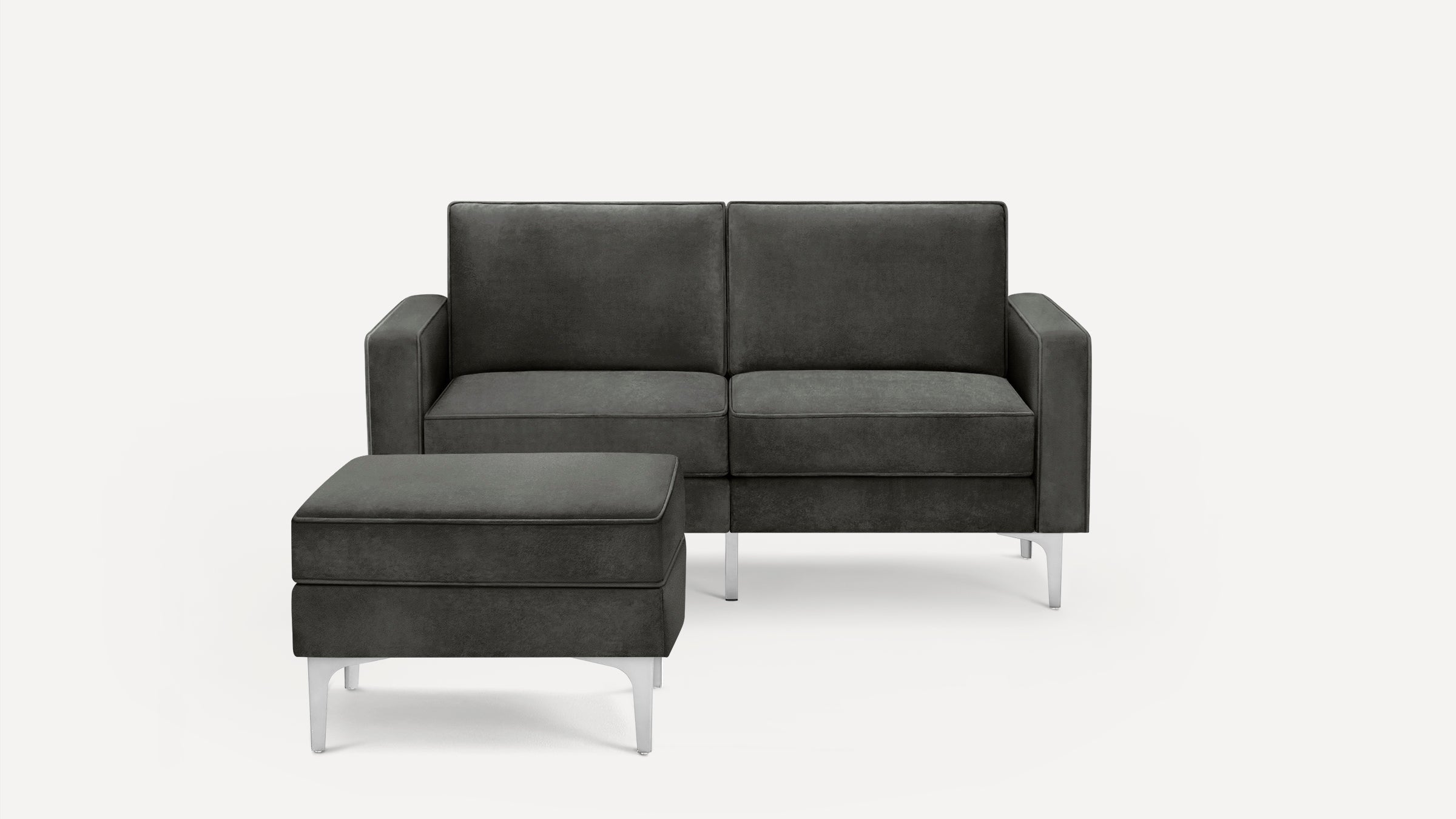 Dark gray modern loveseat with matching ottoman, featuring clean lines and metal legs on a white background.