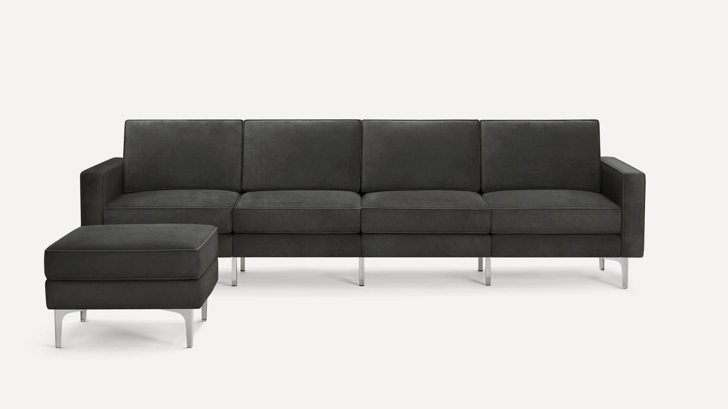 Modern dark gray sectional sofa with clean lines, metal legs, and a matching ottoman on a white background.
