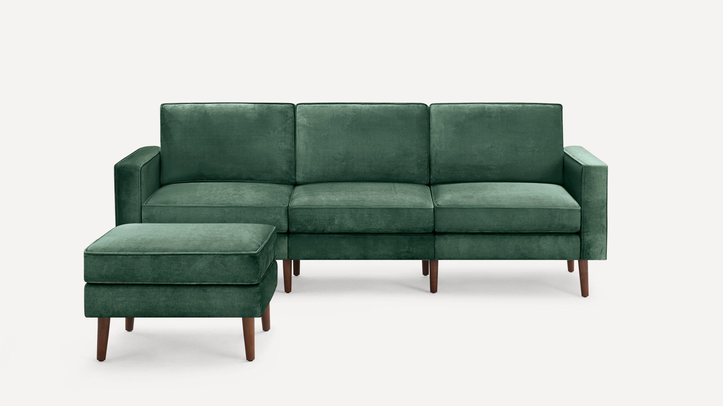 Green fabric upholstered three-seater sofa with matching ottoman, featuring wooden legs and a modern, minimalist design.