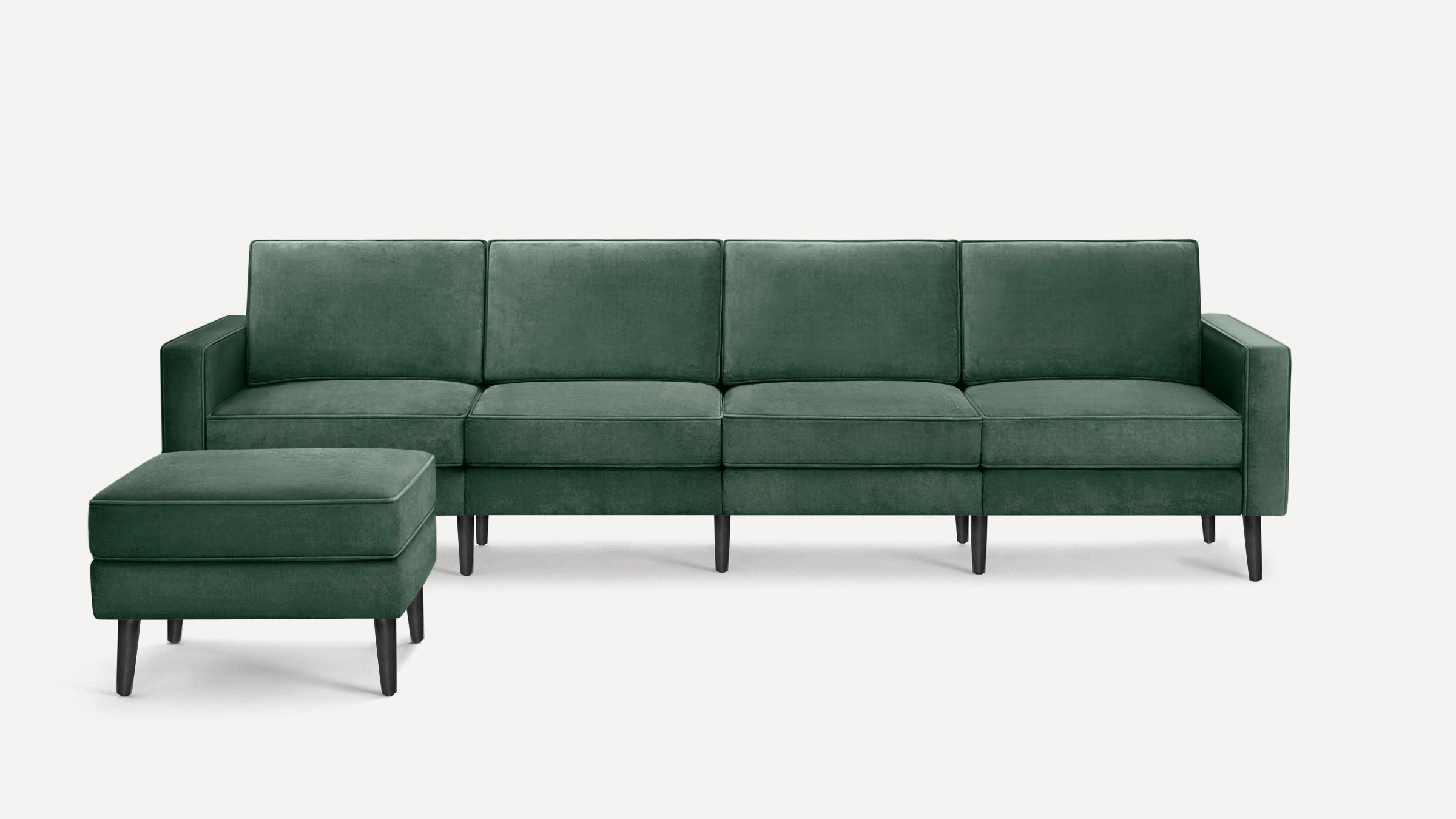 Dark green velvet four-seater sofa with clean lines and matching cushioned ottoman on black wooden legs.