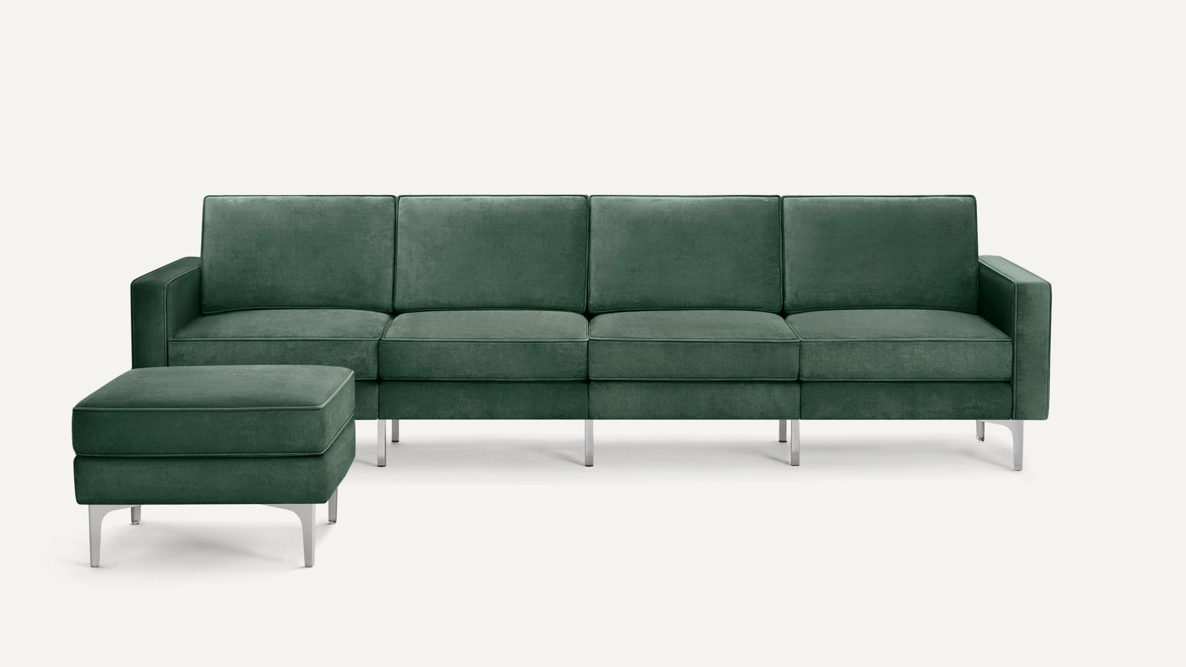 Green velvet sectional sofa with matching ottoman, clean lines, and sleek silver metal legs on a white background.