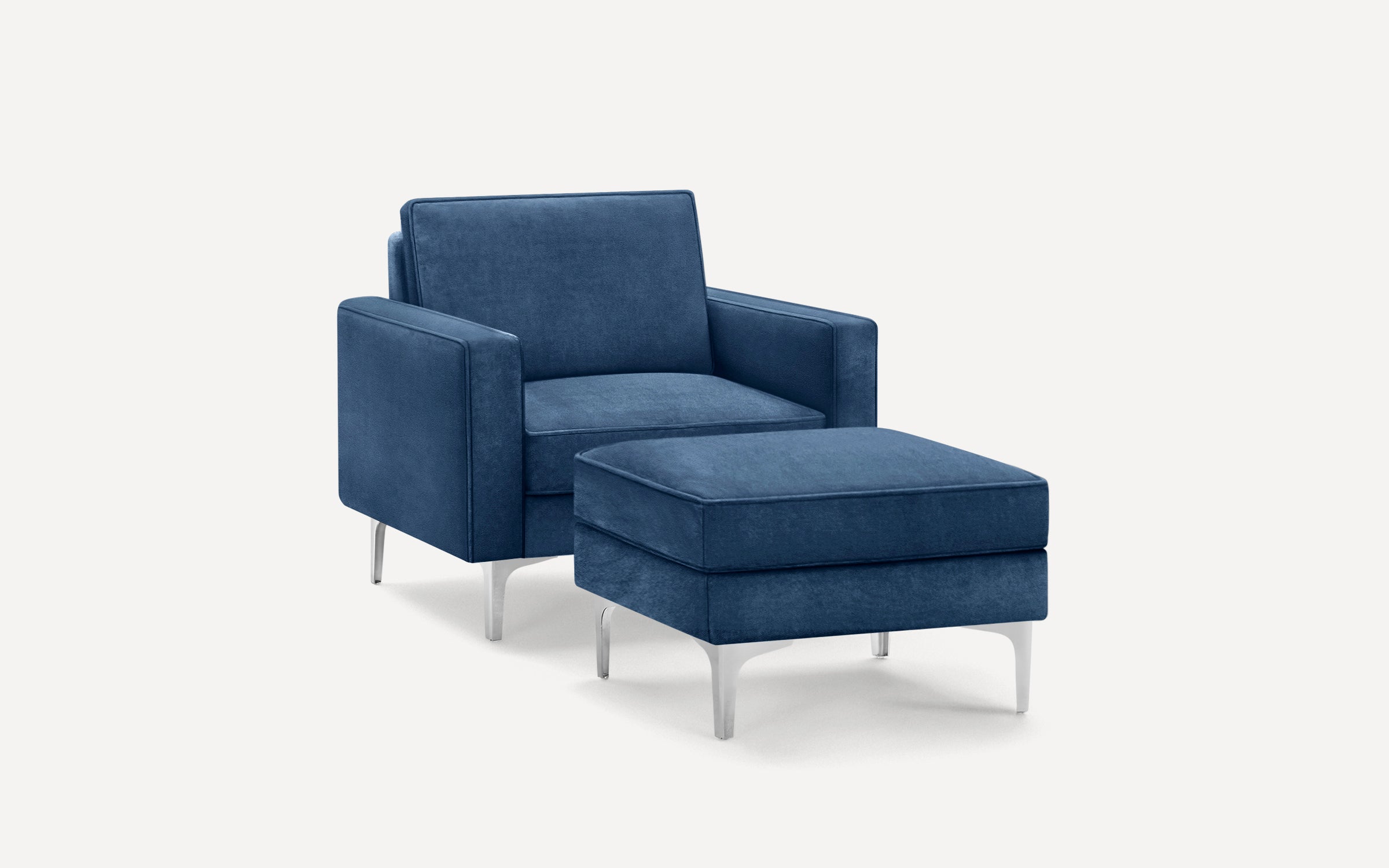 Modern blue upholstered armchair with matching ottoman, featuring sleek metal legs and clean, minimalist design.