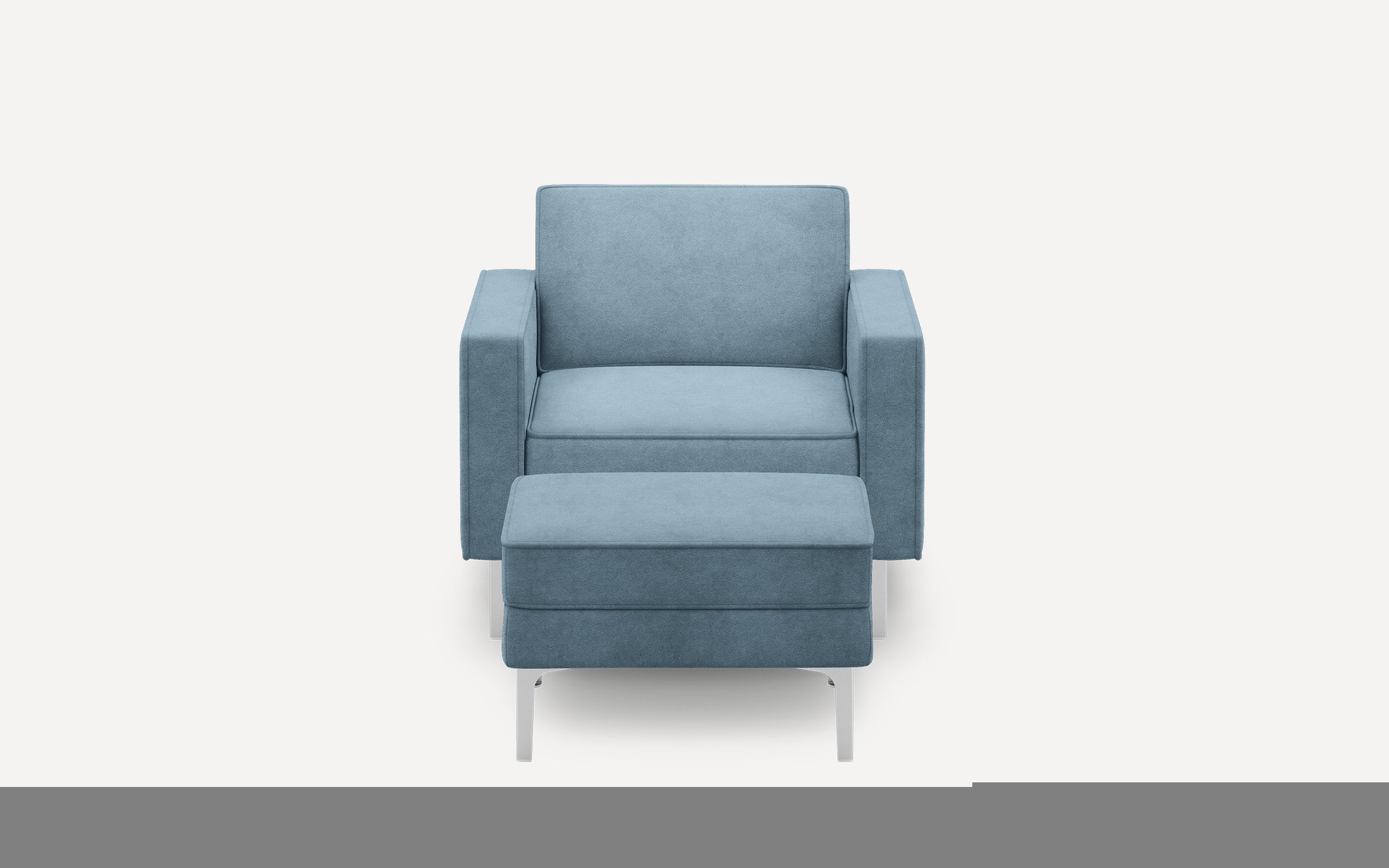 Modern blue upholstered armchair with matching ottoman, featuring sleek silver metal legs.