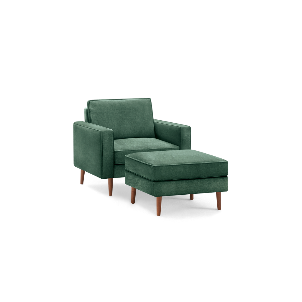 modern green upholstered armchair with matching ottoman, featuring tapered wooden legs and a sleek backrest