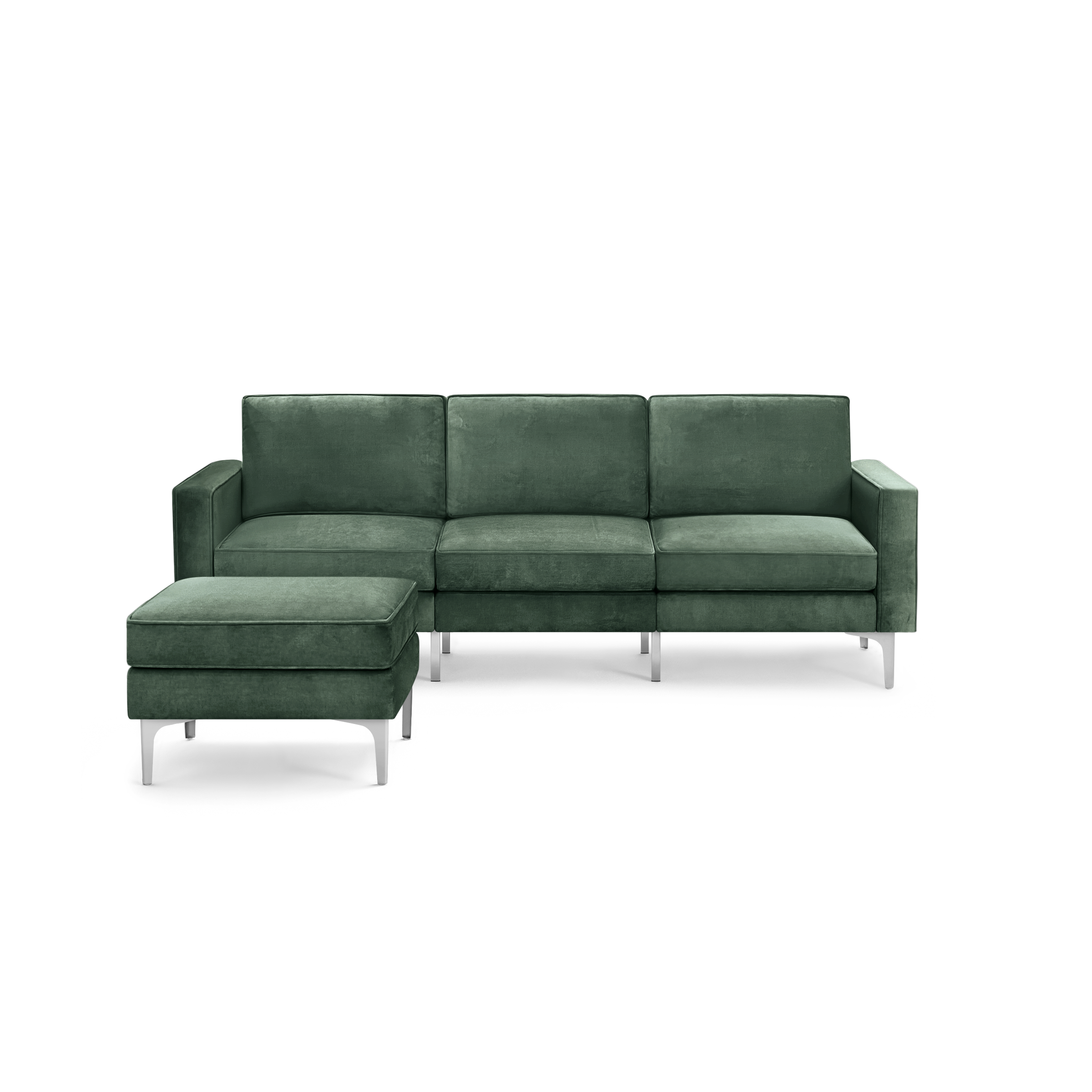 modern green velvet sectional sofa with chrome legs and clean lines on the back, featuring a deep cushioned seat and matching ottoman