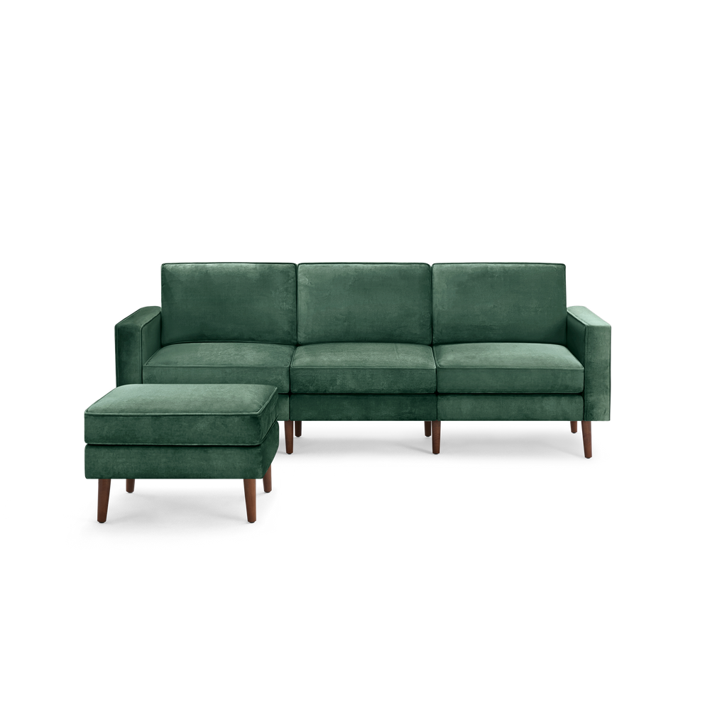 modern green velvet sectional sofa with wooden legs and matching ottoman, featuring a clean, minimal design