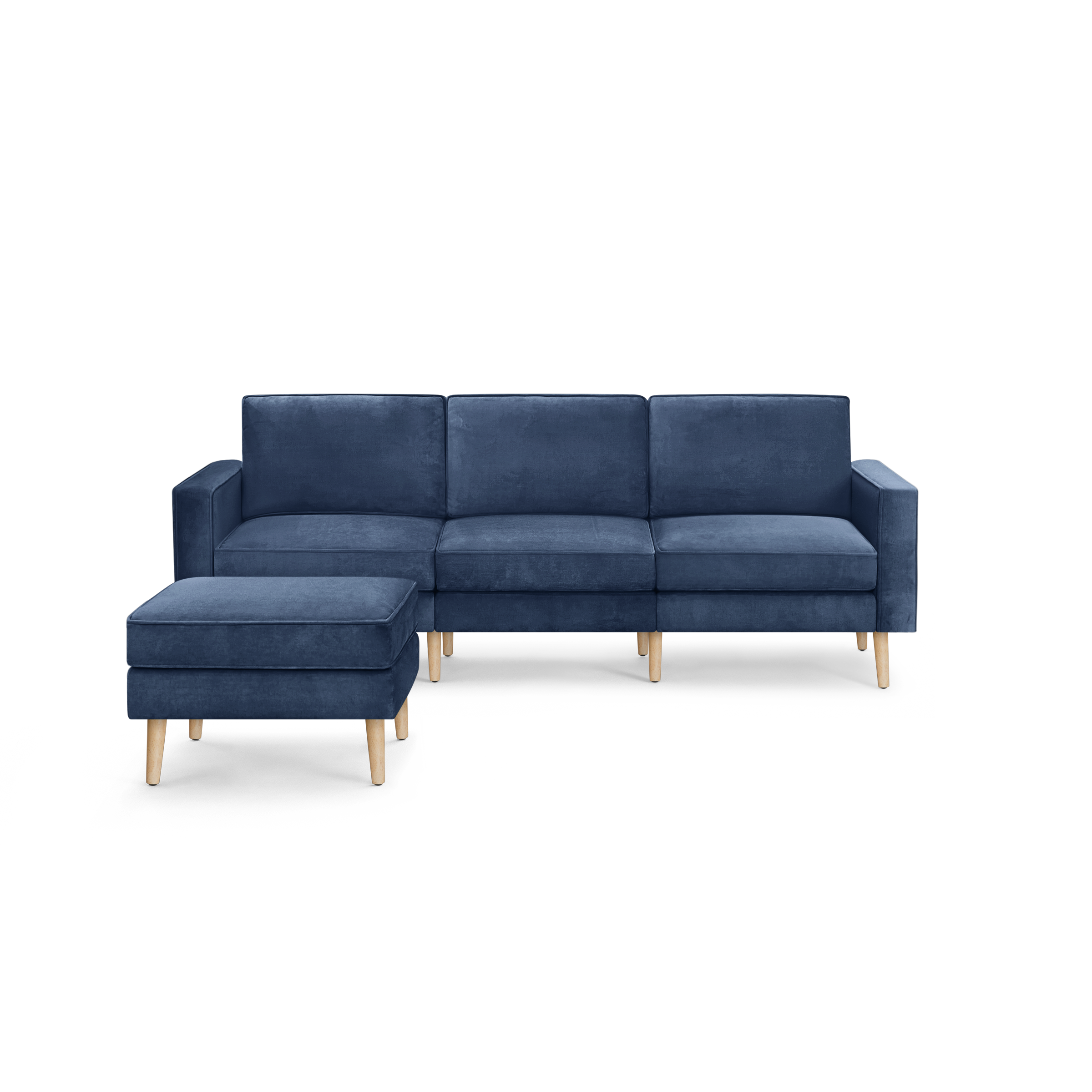 modern blue velvet sectional sofa with wooden legs and clean lines on the back, featuring a chaise lounge and matching ottoman