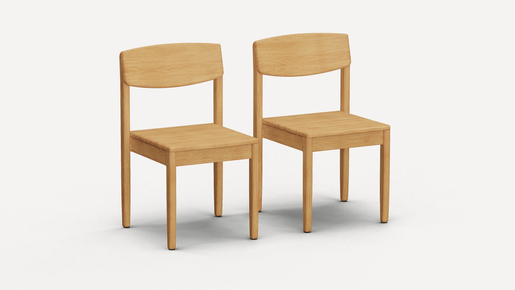 Two simple, light wood dining chairs with curved backrests and square seats on a white background.
