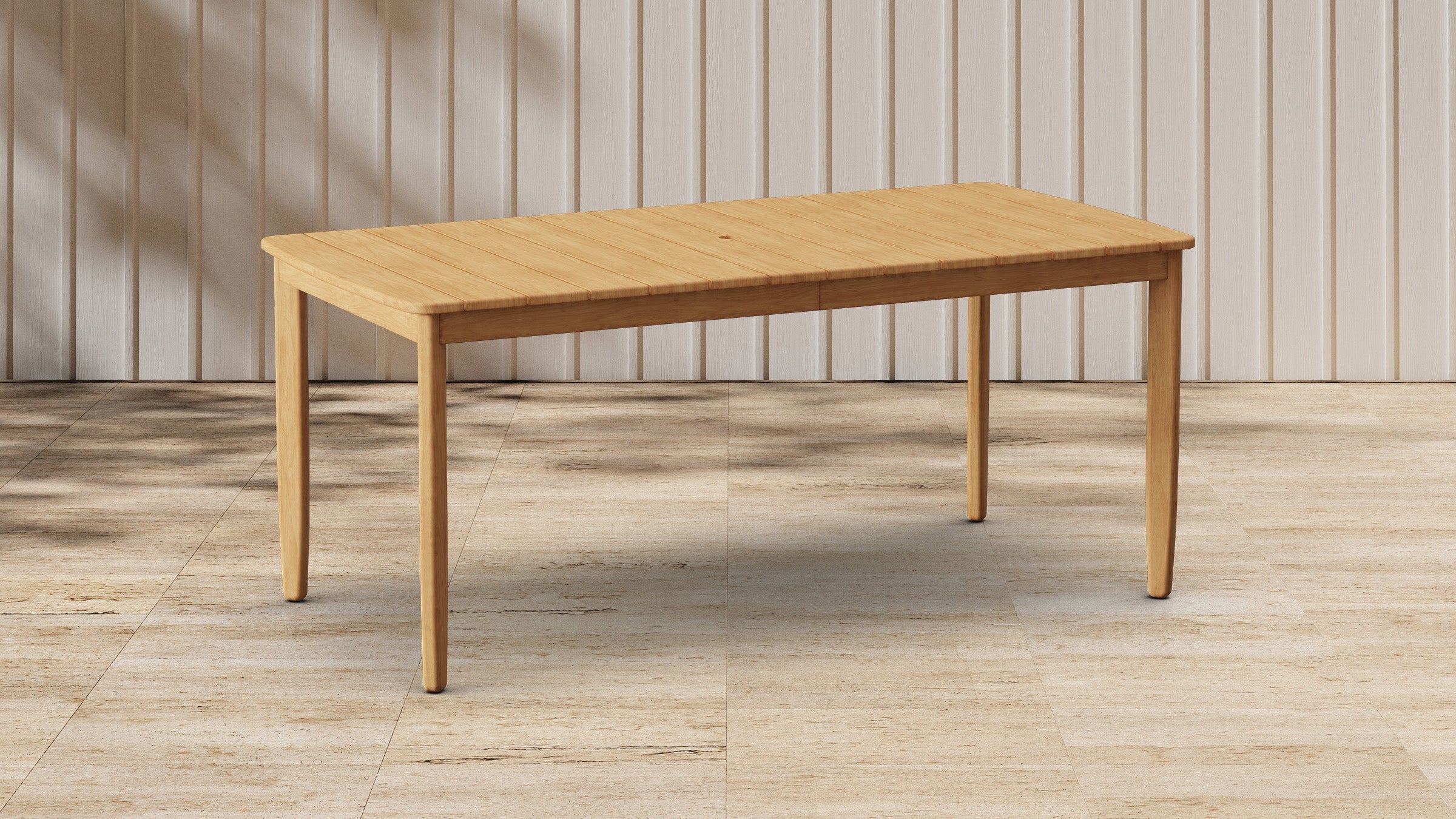 Rectangular wooden dining table with smooth surface and rounded edges, standing on four tapered legs in minimalistic room.