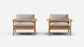 Two identical armchairs with light wooden frames and beige cushioned seats and backrests, against a plain white background.