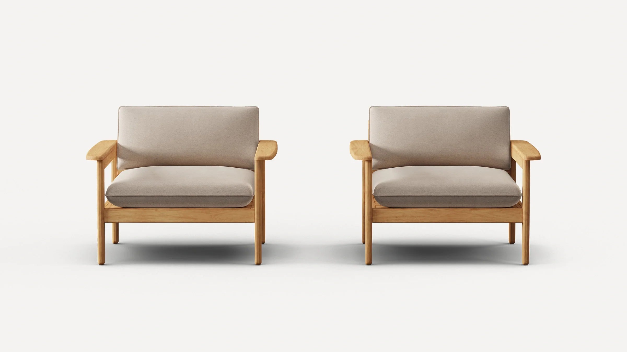 Two identical armchairs with light wooden frames and beige cushioned seats and backrests, against a plain white background.