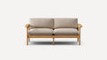 Two-seater sofa with light beige cushions and natural wood frame against a white background.