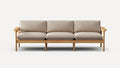 Three-seater sofa with light beige cushions and a wooden frame featuring armrests and six legs, in a minimalist style.