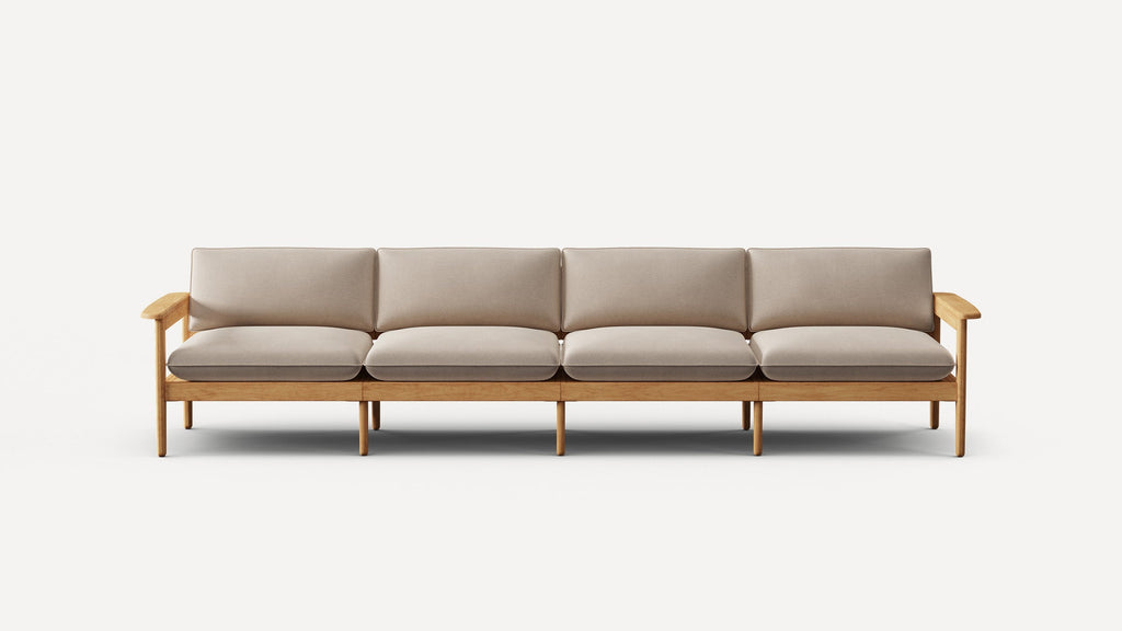 Modern four-seater sofa with light beige cushions and natural wood frame, featuring armrests and multiple legs for support.