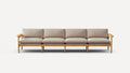 Modern four-seater sofa with light beige cushions and natural wood frame, featuring armrests and multiple legs for support.