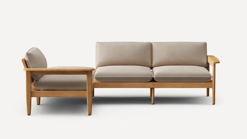 Modern two-seater sofa with beige cushions and light wood frame, featuring clean lines and minimalist design.
