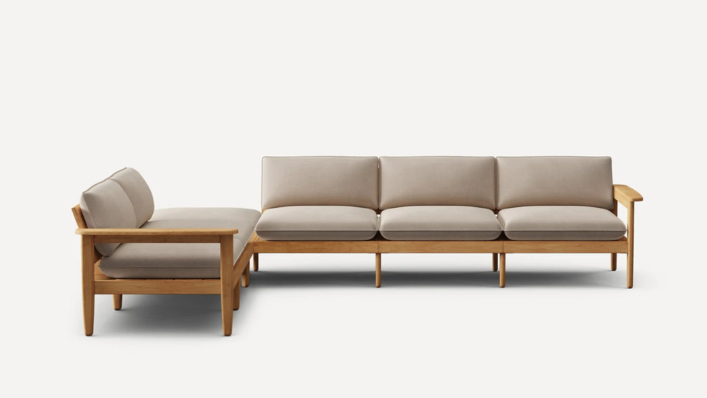 Modern L-shaped sectional sofa with beige cushions and light wooden frame, designed for indoor living spaces.