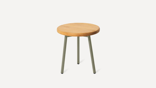 a small wooden stool with metal legs and a light green top