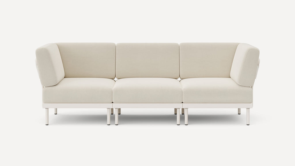 modern beige fabric sofa with metal legs and clean lines on the back, featuring a clean, minimalist design