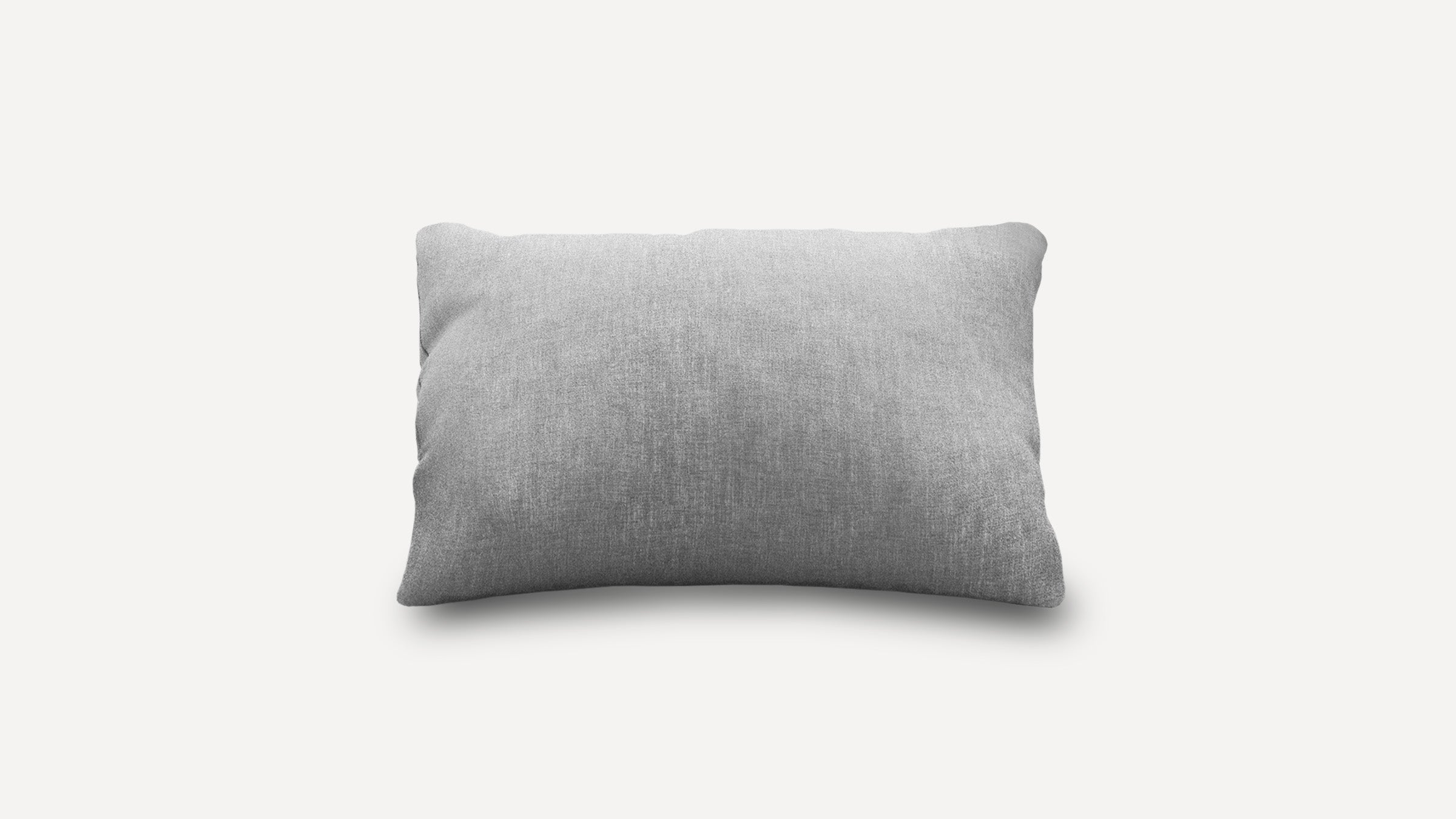 Rectangular light gray pillow with a soft fabric texture, slightly curved edges, displayed on a white background.