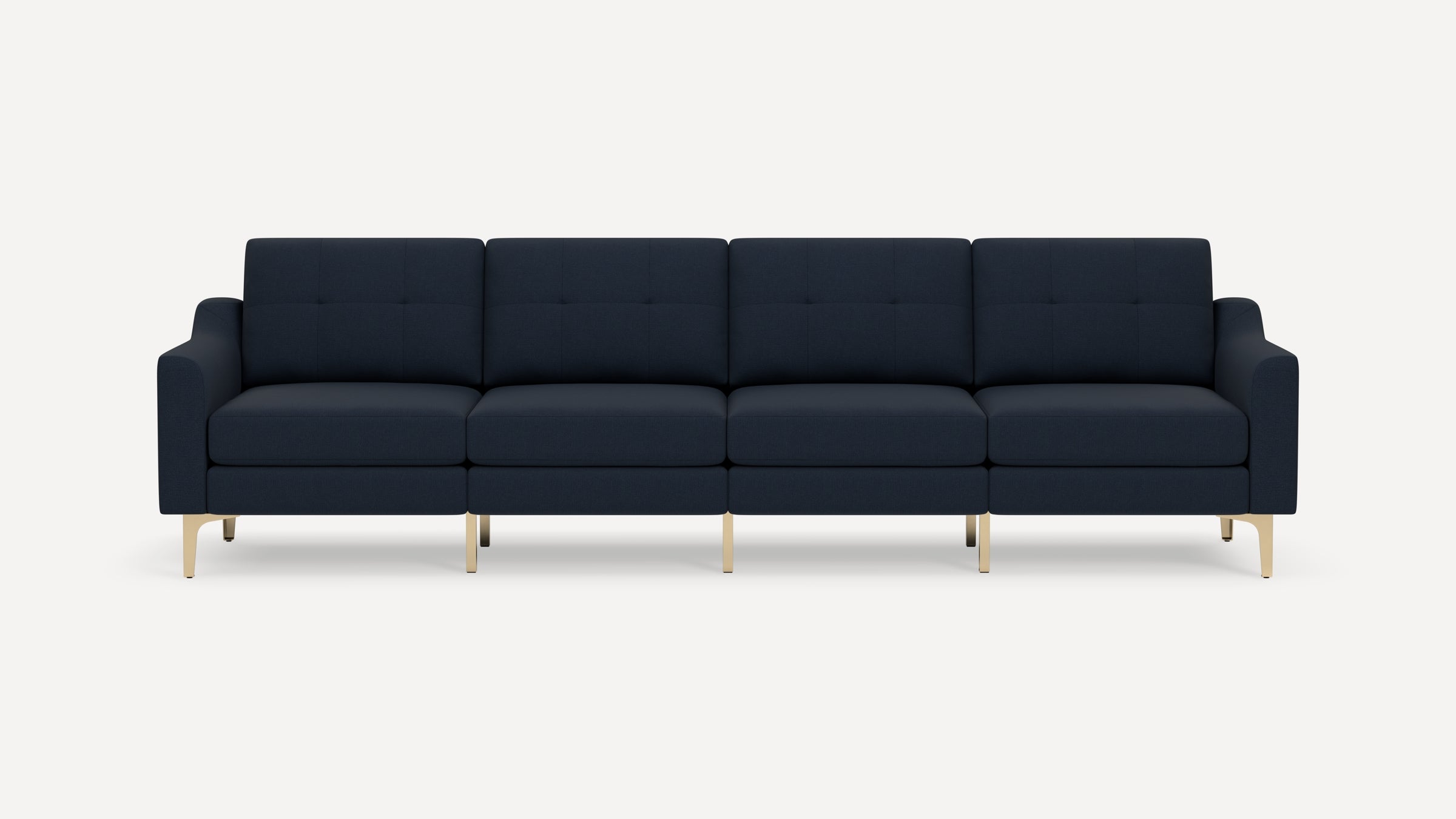 Modern navy blue four-seater sofa with tufted cushions, curved armrests, and sleek gold metal legs on a white background.