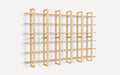 Large minimalist wooden wall-mounted shelving unit with multiple horizontal shelves and vertical supports, designed for modern interior storage and display.