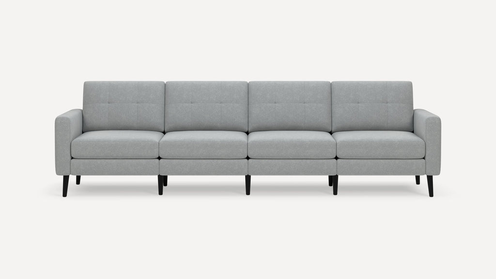 Light gray modern four-seat sofa with tufted back cushions and black tapered legs on a white background.