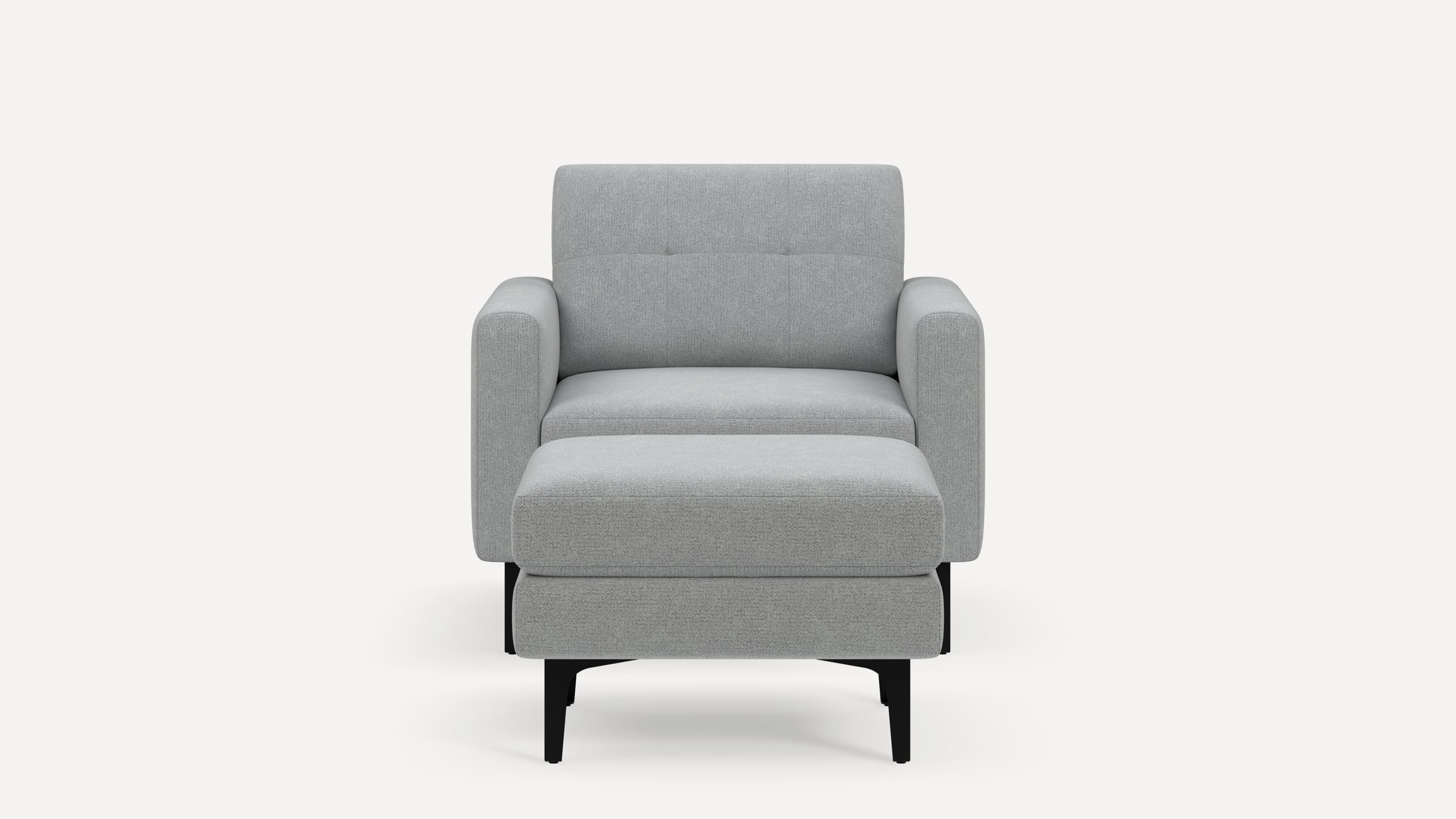 Front view of a modern, light gray upholstered armchair with a matching ottoman and black legs.