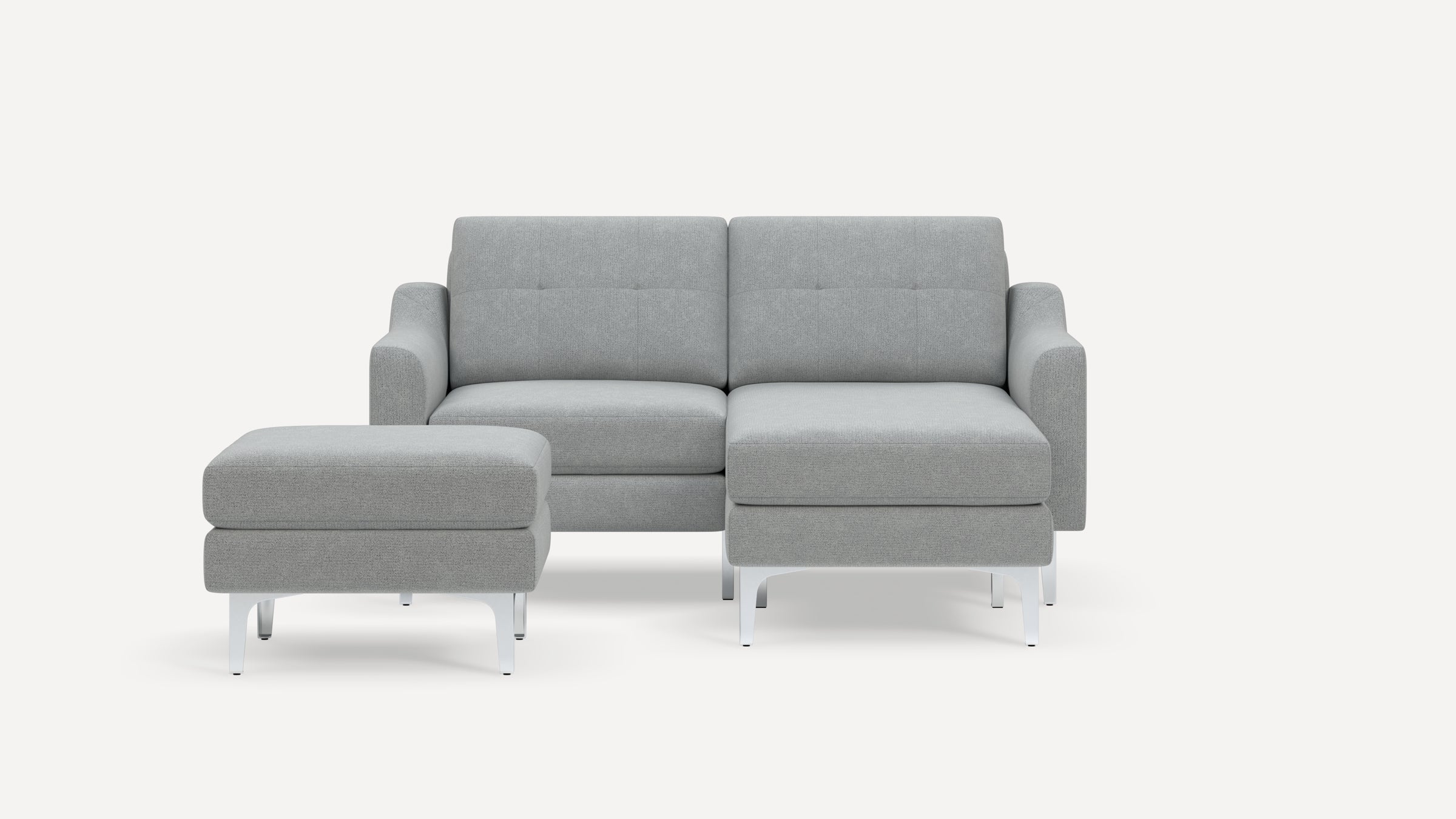 Modern light gray sectional sofa with metal legs, tufted backrests, and matching ottoman on a white background.