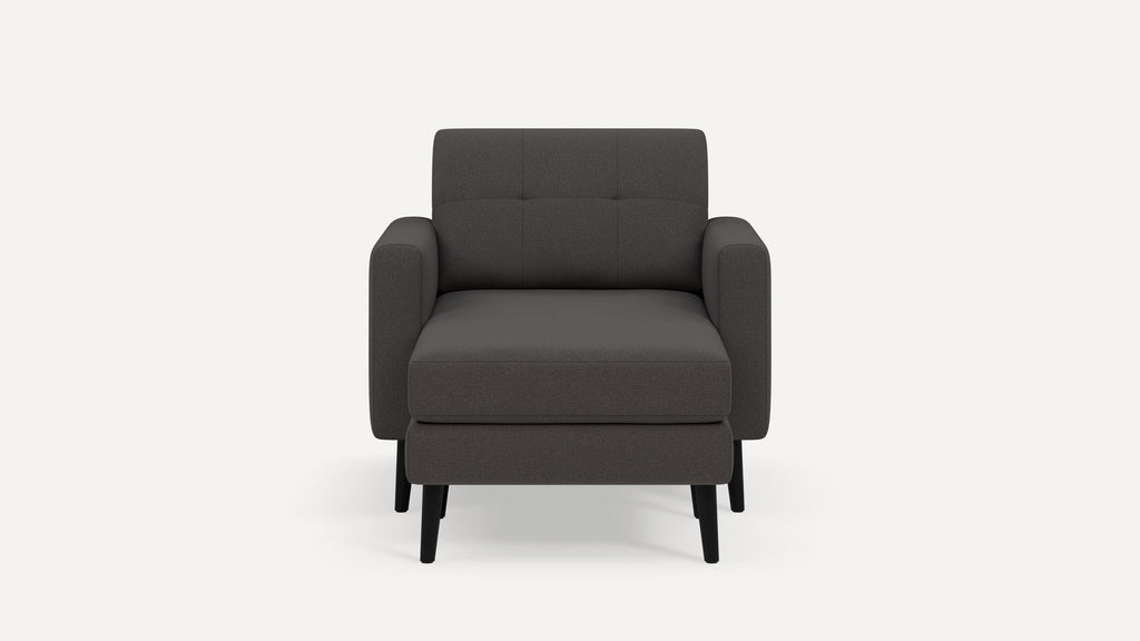 Front view of a modern dark gray armchair with squared arms, cushioned backrest, and black tapered legs on a white background.