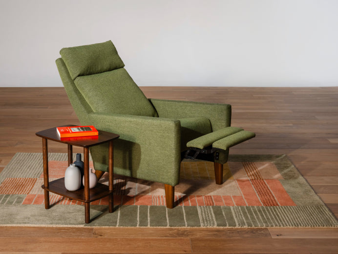 green recal - shaped recal chair with wooden legs