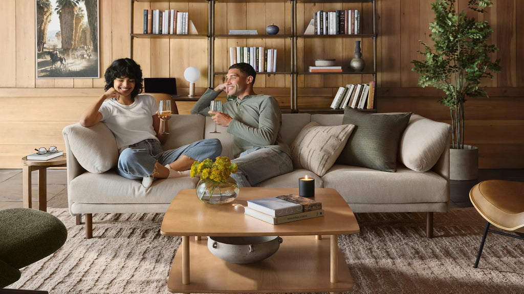 a couple sitting on a couch in a living room