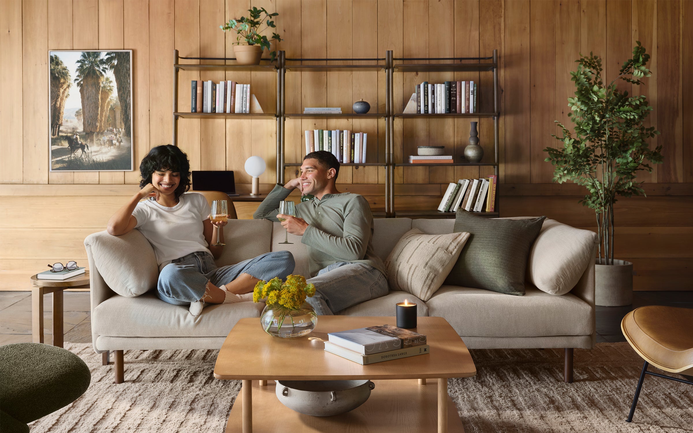 man and woman sitting on Burrow Range modular sofa enjoying wine