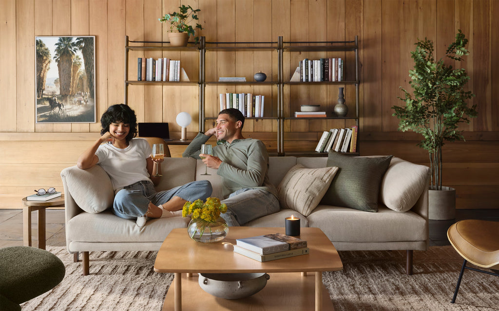 man and woman sitting on Burrow Range modular sofa enjoying wine