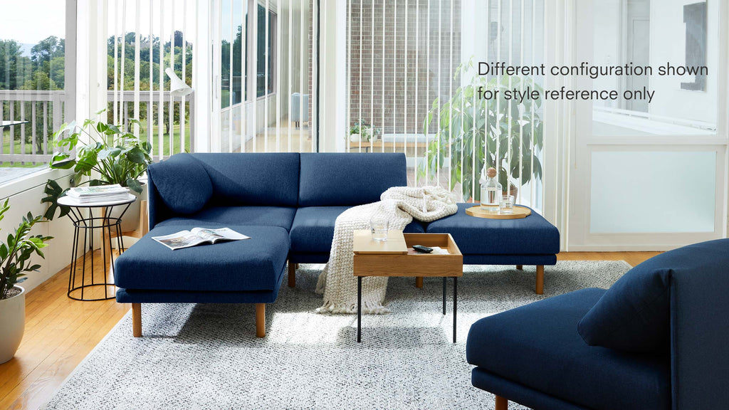 modern blue sectional sofa with wooden legs and matching cushions, featuring a modern coffee table, planters, and a planter