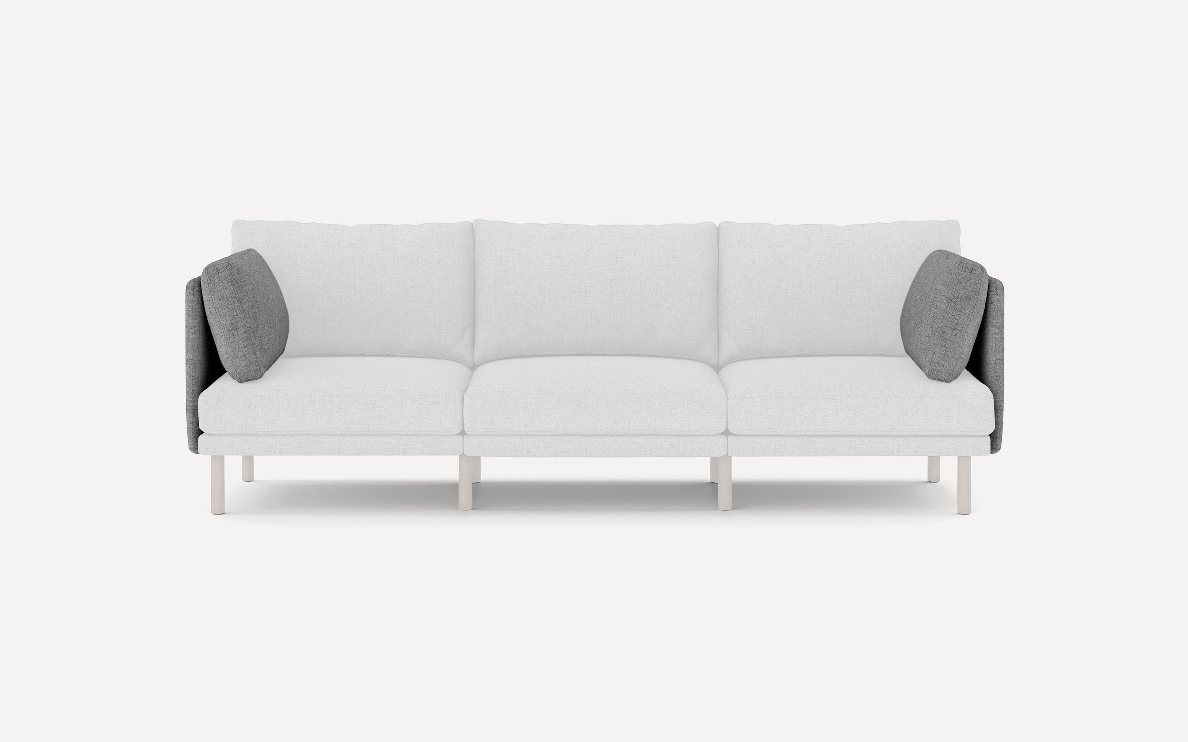 Modern three-seater sofa with light gray cushions and dark gray side pillows, featuring slim wooden legs and clean lines.