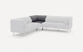 Modern L-shaped sectional sofa with white upholstery and contrasting dark gray corner cushions, supported by slim metal legs.