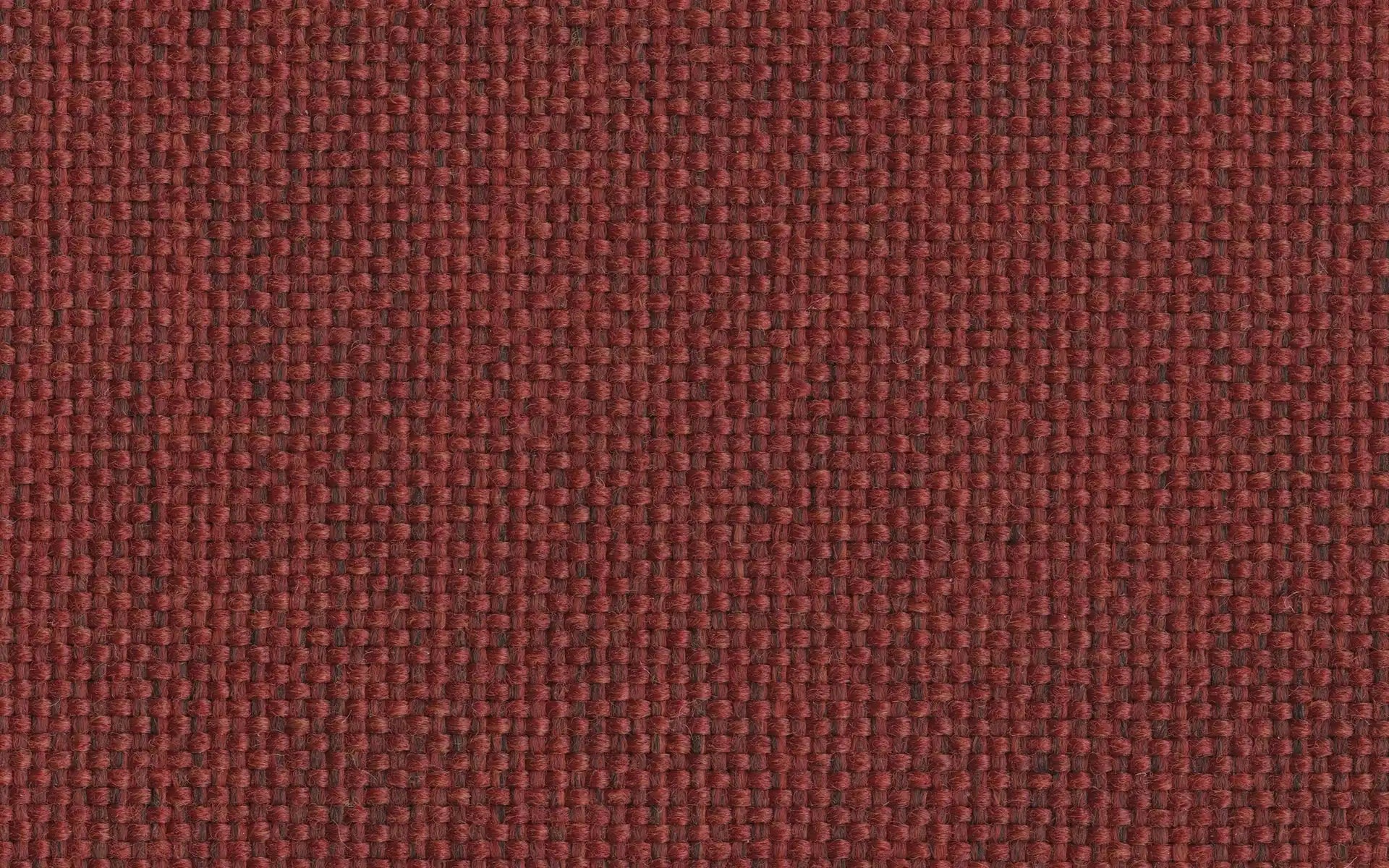 Close-up image of textured woven fabric in deep red and brown tones, showing detailed interlaced fibers.